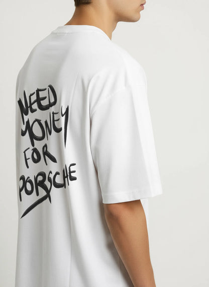 Side view of man wearing white T-shirt with bold graffiti-style text ‘Need Money for Porsche’ on the back — humorous automotive streetwear for Porsche enthusiasts.