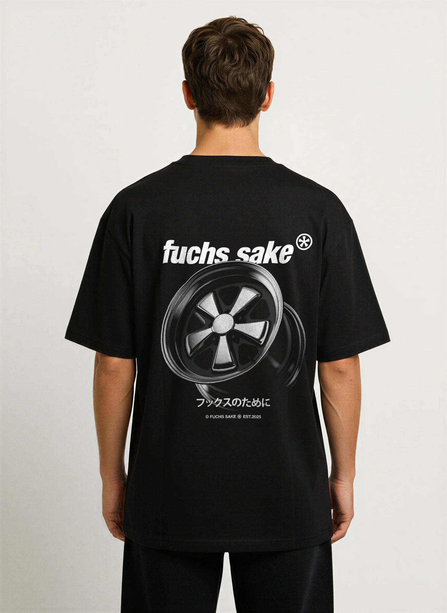 Rear view of black graphic tee featuring Porsche Fuchs wheel print, ‘fuchs sake’ text, and Japanese writing — minimalist automotive apparel for classic car fans.