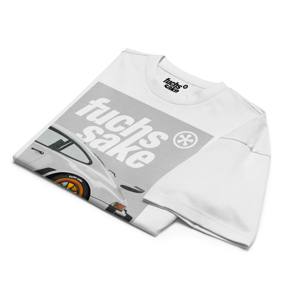 Folded white t-shirt with graphic design and text on a white background