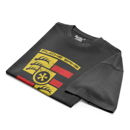 Folded black t-shirt with yellow and red graphic design on a white background