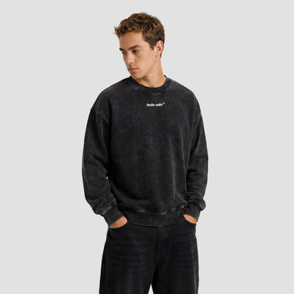 Person wearing a black sweatshirt with a Fuchs Sake logo on a plain background