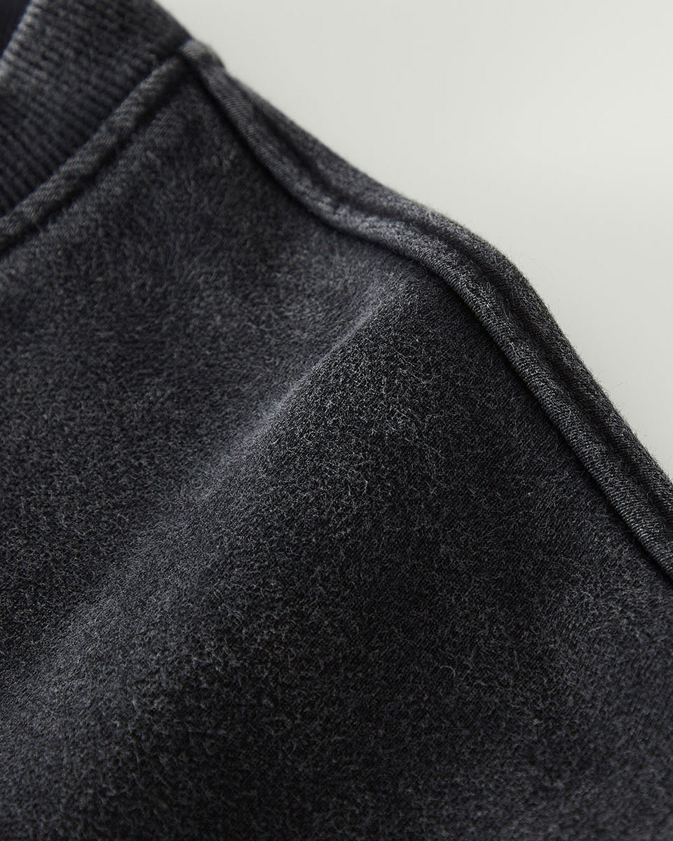 Close-up of dark gray fabric texture on a light gray background
