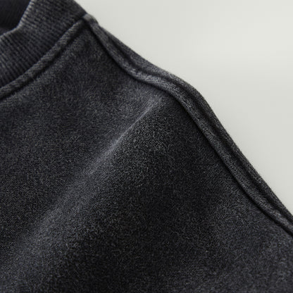 Close-up of dark gray fabric texture on a light gray background