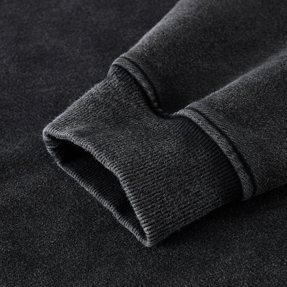 Close-up of a dark gray fleece fabric with a textured surface on a black background