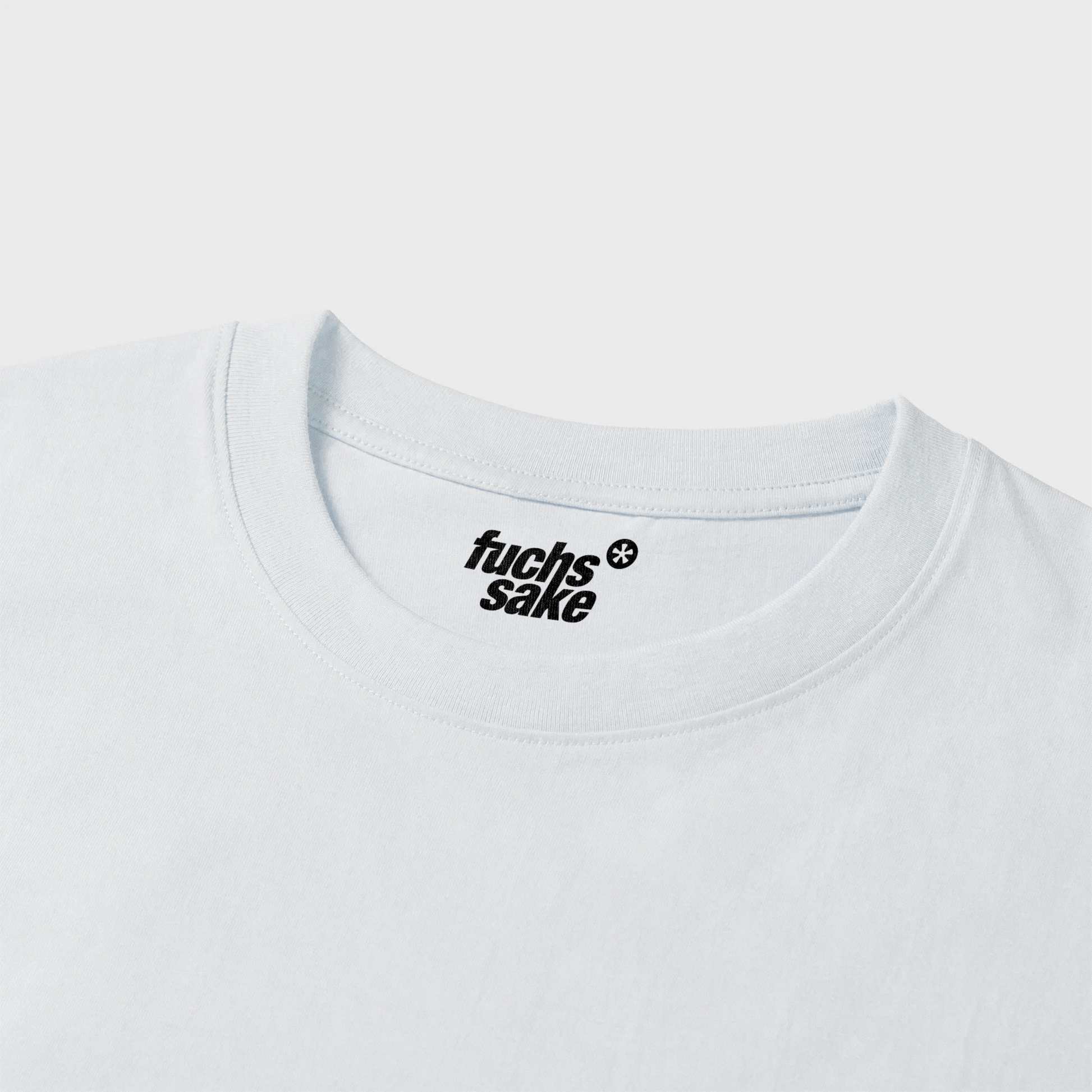 White t-shirt with 'fuchs'sake' logo on a light gray background