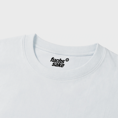 White t-shirt with 'fuchs'sake' logo on a light gray background