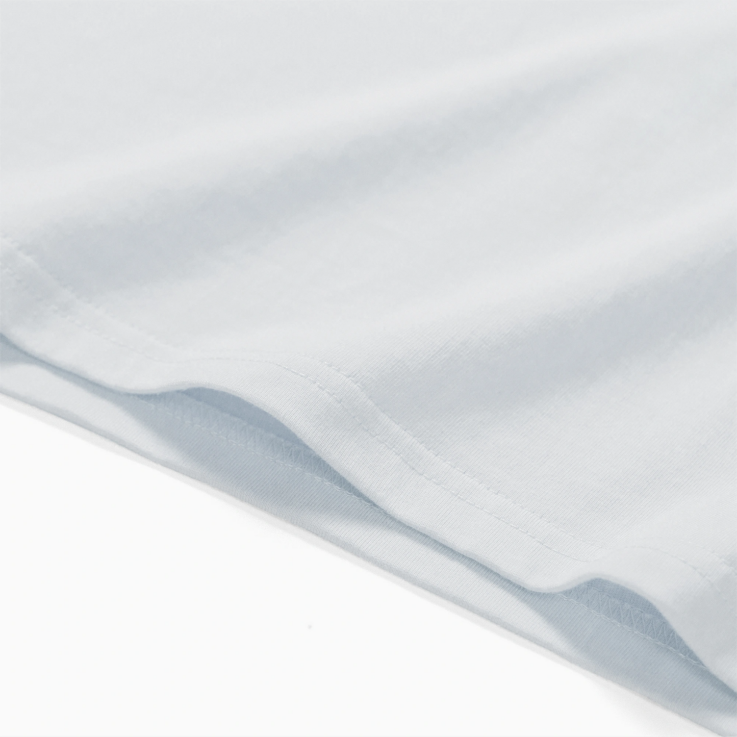 Close-up of a white fabric with subtle texture on a white background