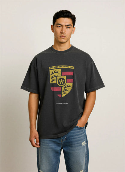 Back view of man in charcoal grey ‘fuchs sake’ T-shirt — minimalist design celebrating classic Porsche heritage and automotive lifestyle